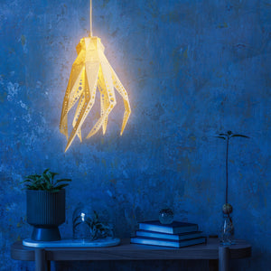 An eco-friendly Vasili Lights Octopus Light hangs on the blue wall, resembling the hand of Octavio the Octopus.