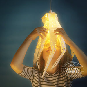 A girl holding up an eco-friendly Vasili Lights Octopus Light in her child's room.