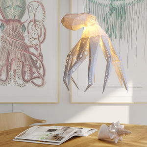 Octavio the Vasili Lights Octopus Light hanging from an eco-friendly lamp in a room.