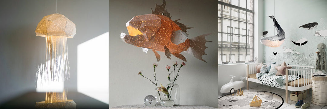 Three panels: a jellyfish lamp glowing in a sunlit corner, an orange fish lamp lit above two carnations in a jar, and a whale and an octopus lamp above a cot in a nursery with a painted whale mural