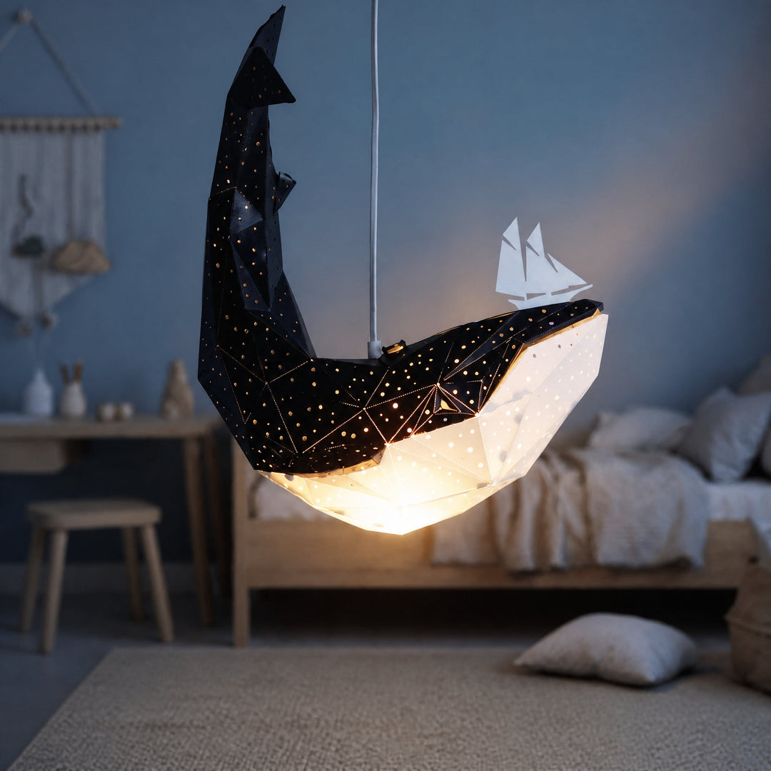 A lit Black-White Baby Whale Pendant Light in a blue bedroom