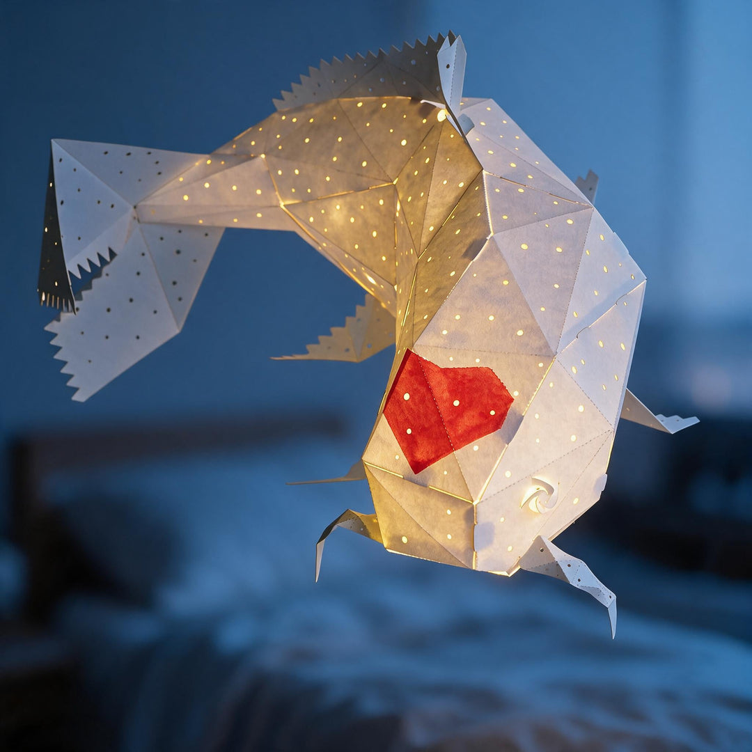 A lit Ember Koi Pendant Light with its red heart in a dark blue bedroom