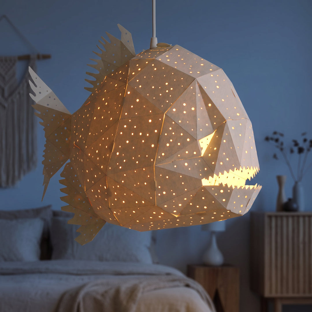 A lit White Glowfish Origami Pendant Light in a blue bedroom