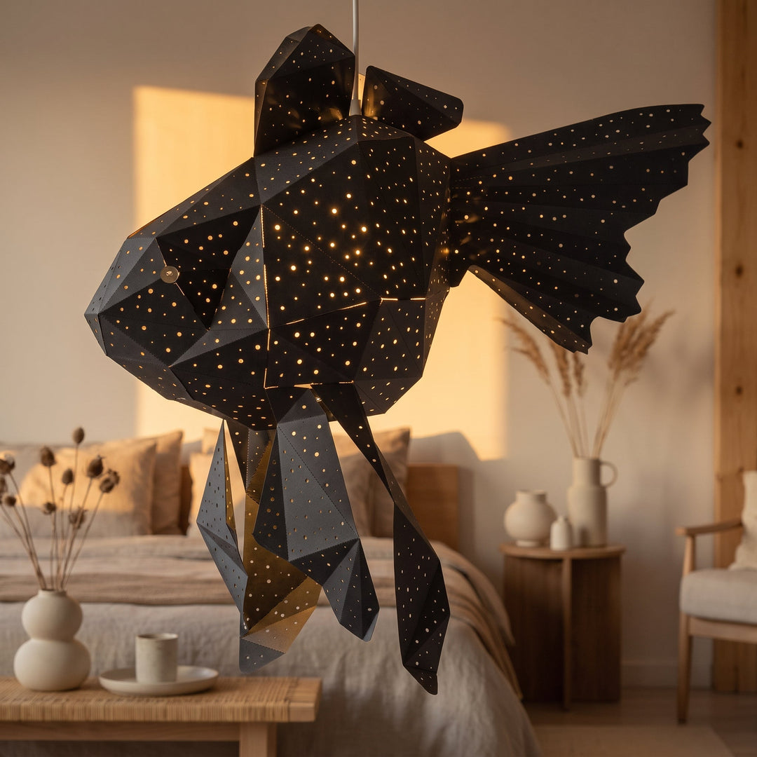 A lit Black Goldfish Origami Pendant Light in a sunlit room