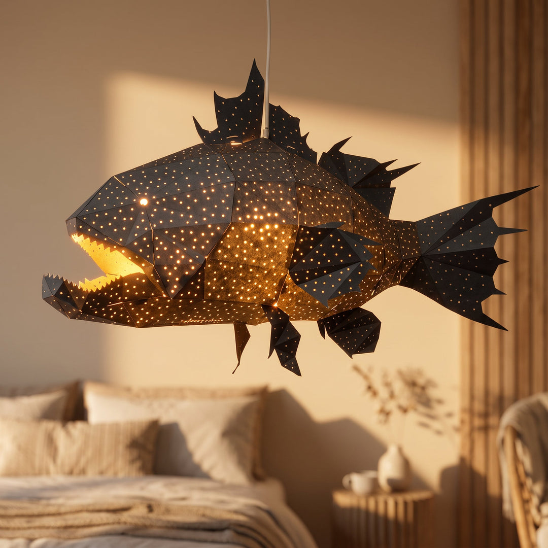 A lit Black Lapu Lapu Origami Fish Pendant Light in a warm bedroom
