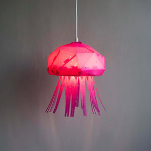Vasili Lights' Baby Jelly Lamp for Nursery, shaped as a jellyfish, hanging from a ceiling, pink color.