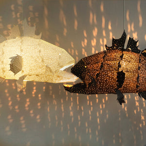 Nautical Ceiling Lamps of black and white colors, shaped like a deep sea fish, creating a underwater ambiance.