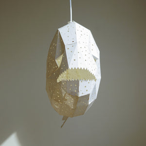 A whimsical Nautical Hanging Light Glowfish hanging from a ceiling, frontal view.