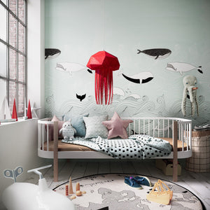 Nautical Ceiling Lamp shaped as jellyfish in a children's room with a window, bed, a rug and ocean-themed wallpaper.
